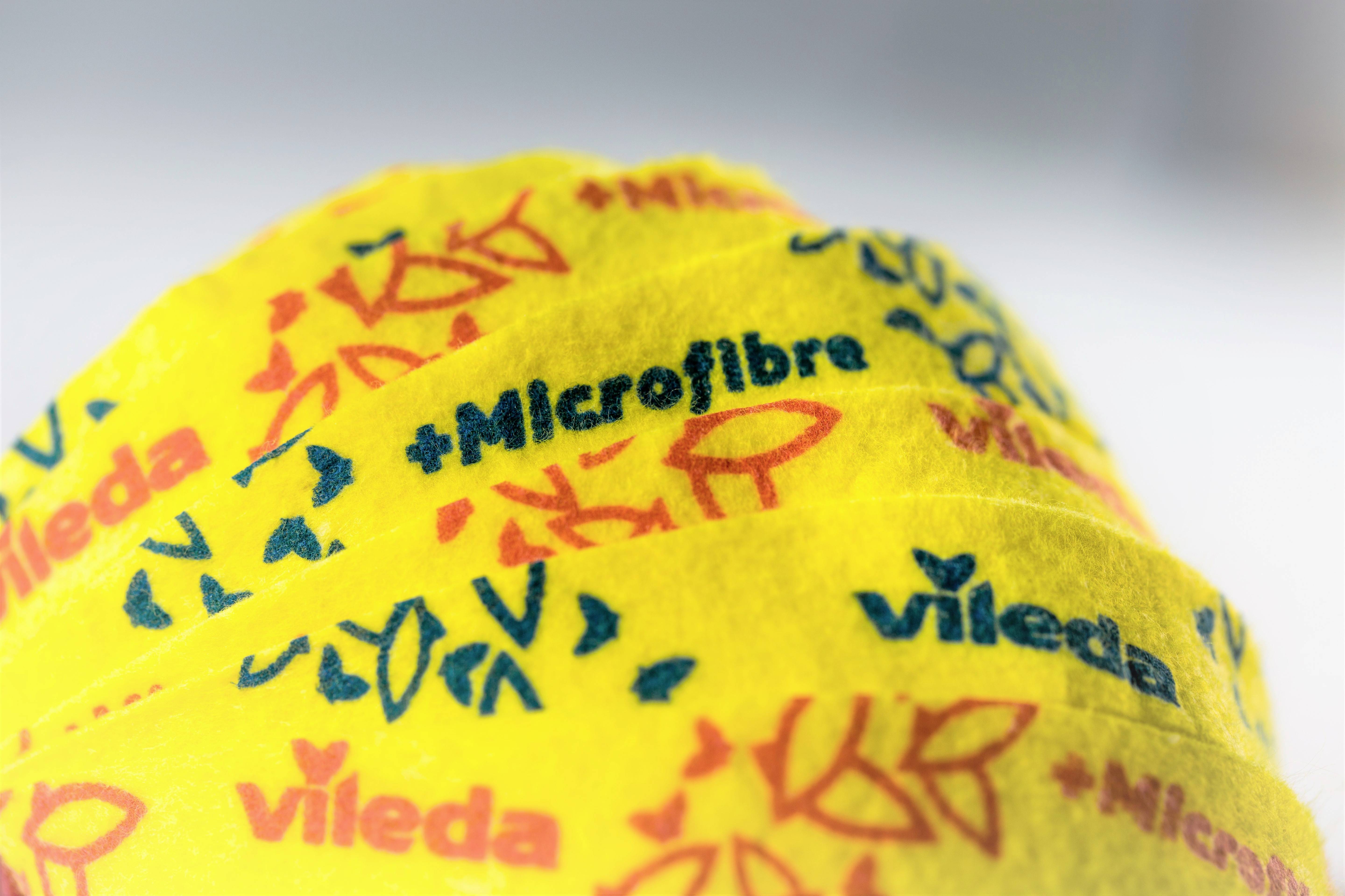 Yellow cleaning cloths with '+Microfibre' written in blue and 'vileda' in red.