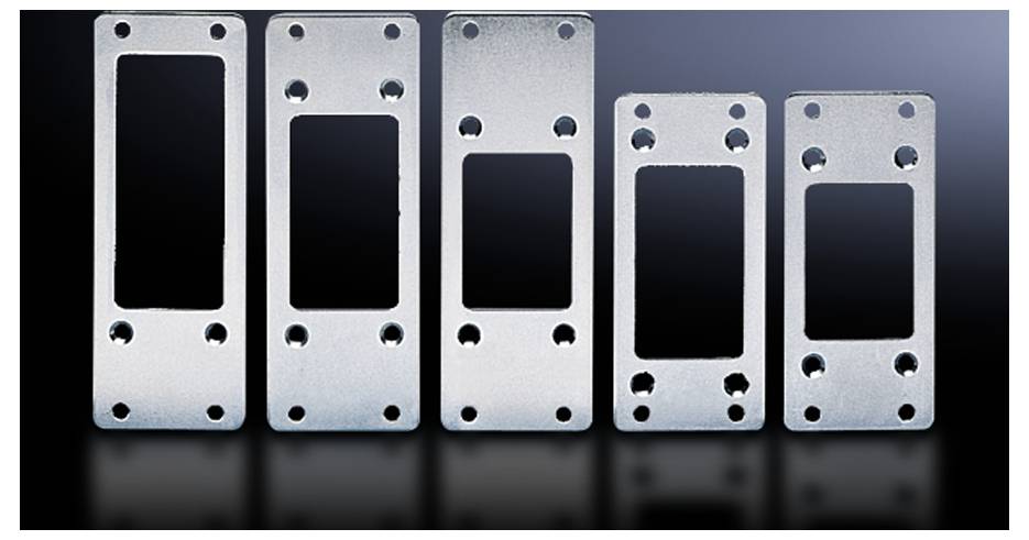 Metal plates in various sizes with rectangular cutouts and drill holes, arranged on a reflective surface.