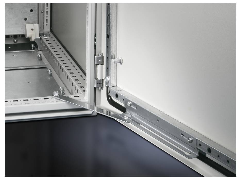 Close-up of an open electrical cabinet with visible hinges, metal braces, and cable channels.