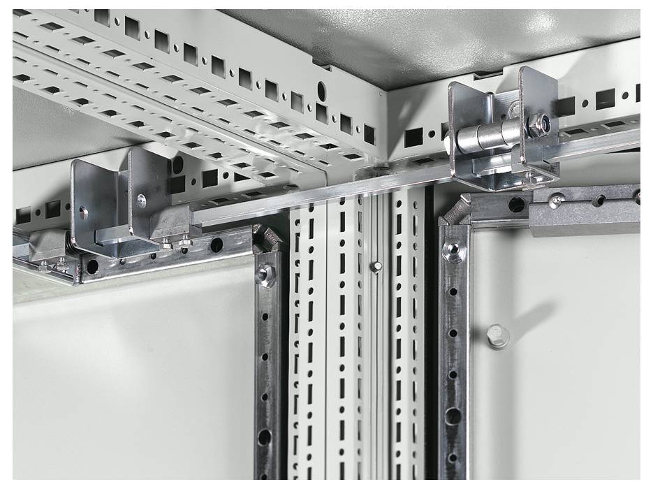 Metal brackets and rails in a cabinet, showing structure and connection elements. Suitable for technical installations.