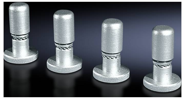 Four silver metal buttons are lined up in a row on a dark surface, with fine ridging at the base.