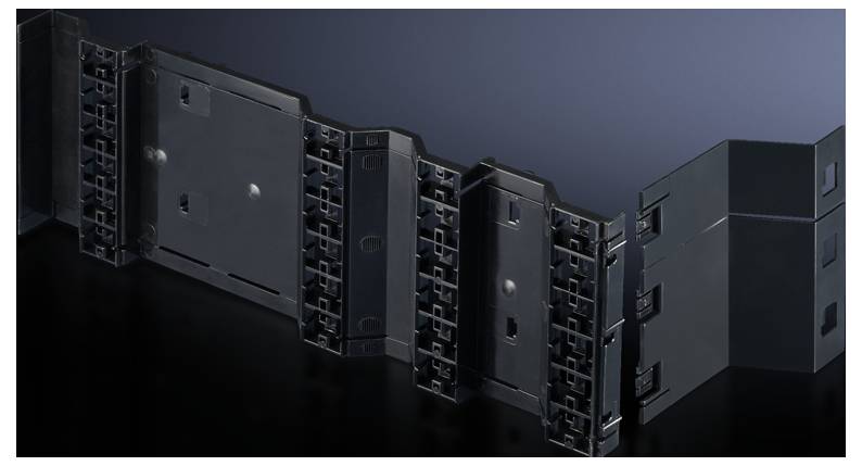 Black plastic component with interlocking segments, which may be part of a technical or industrial part.