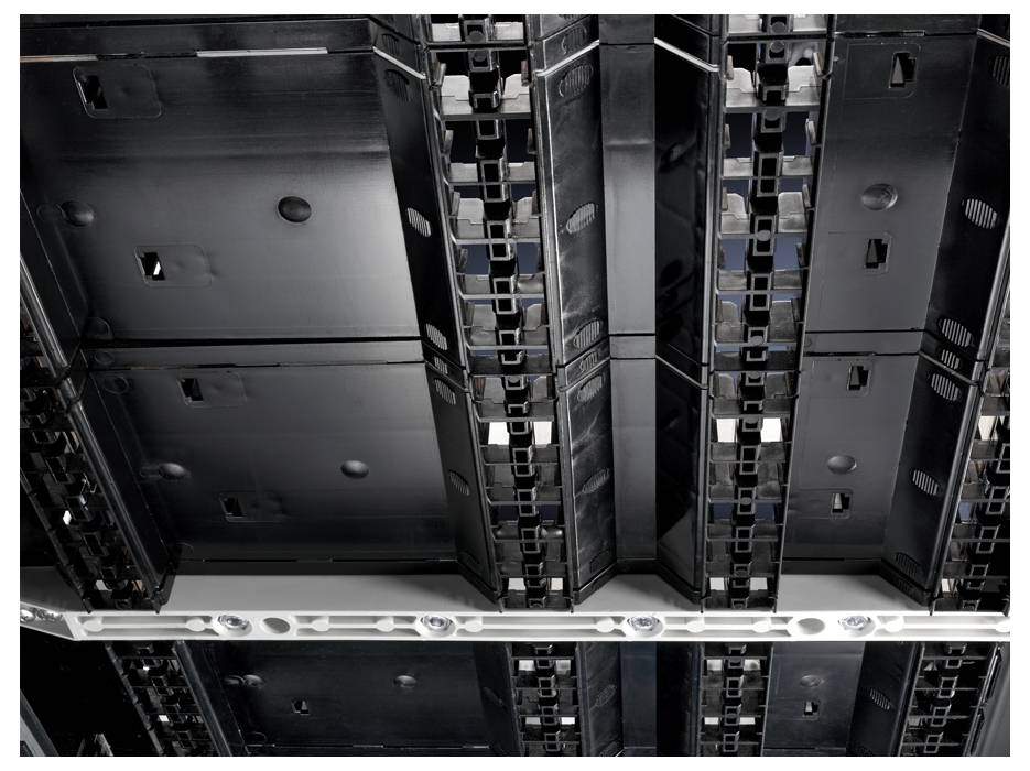 A view of the underside of LED panel ceiling lights in an office building, symmetrically arranged and switched off.