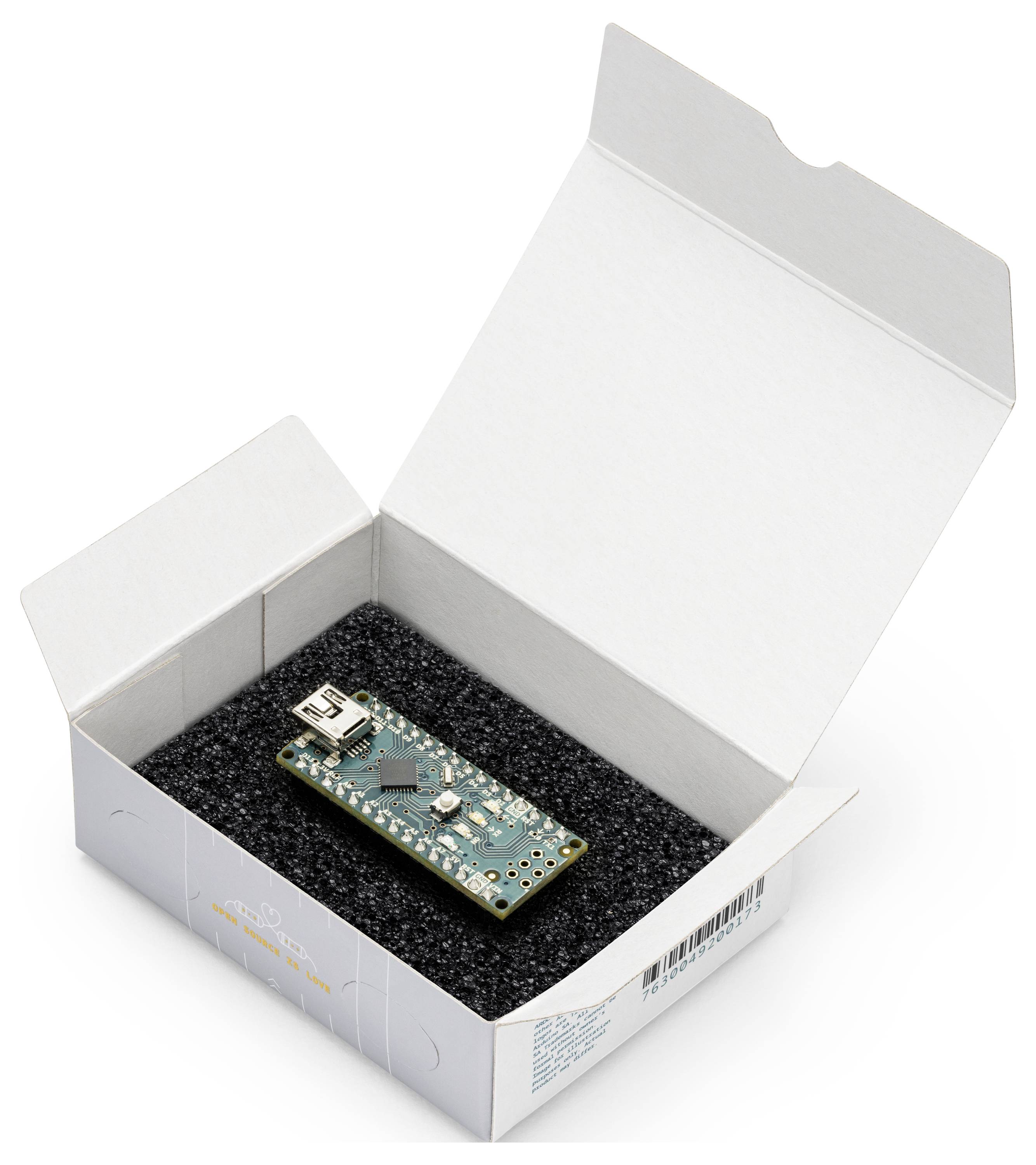 Small circuit board resting in a foam-lined white product box with the lid open on a plain background.