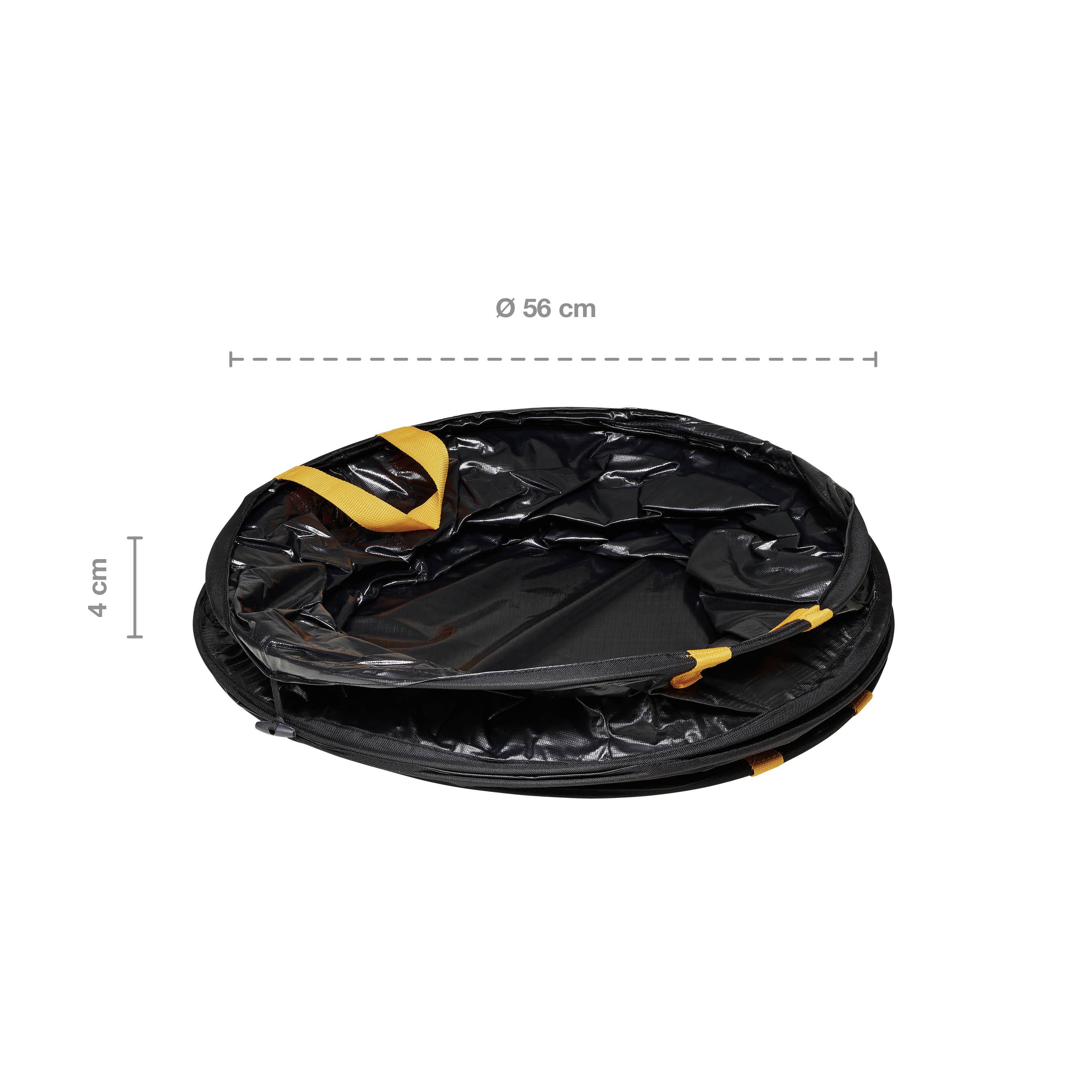Collapsed black round basket, 56 cm in diameter, 4 cm high, with orange straps, on a white background.