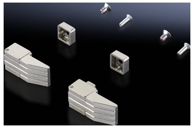 Metal components and screws on a black background, ready to be assembled, potentially for a technical or industrial project.