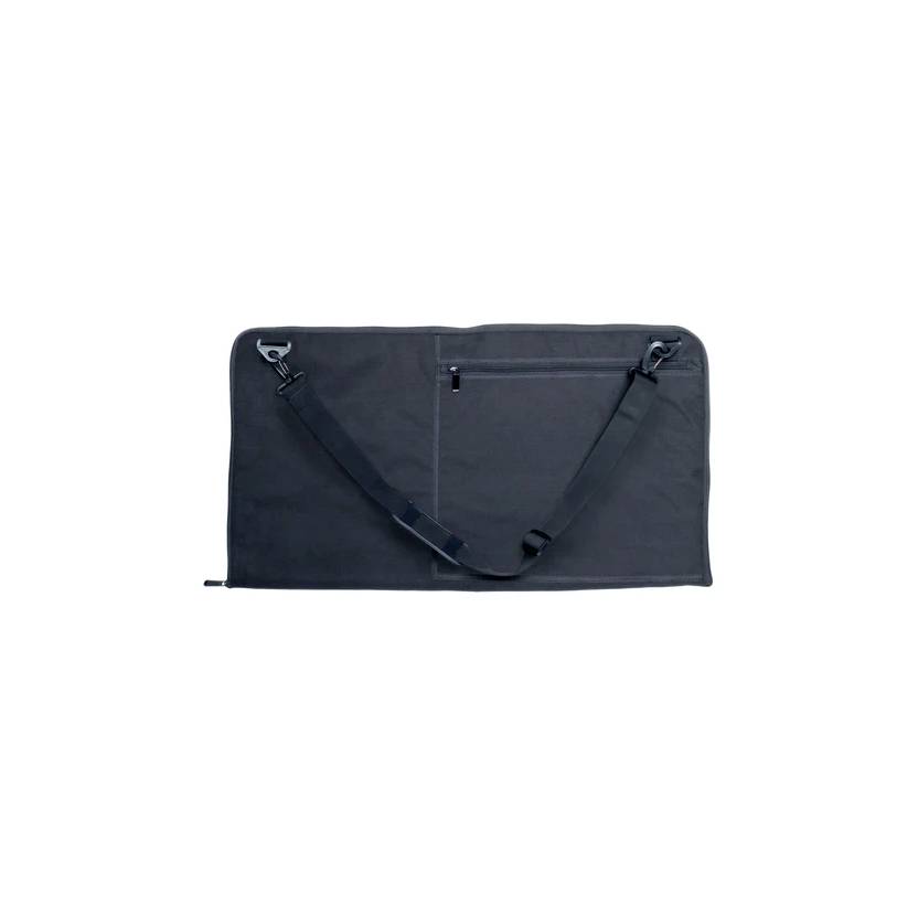 Black bag with adjustable shoulder strap and zipped compartment, laid out flat.