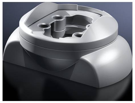 A grey, round plastic base with multiple openings on a dark surface.