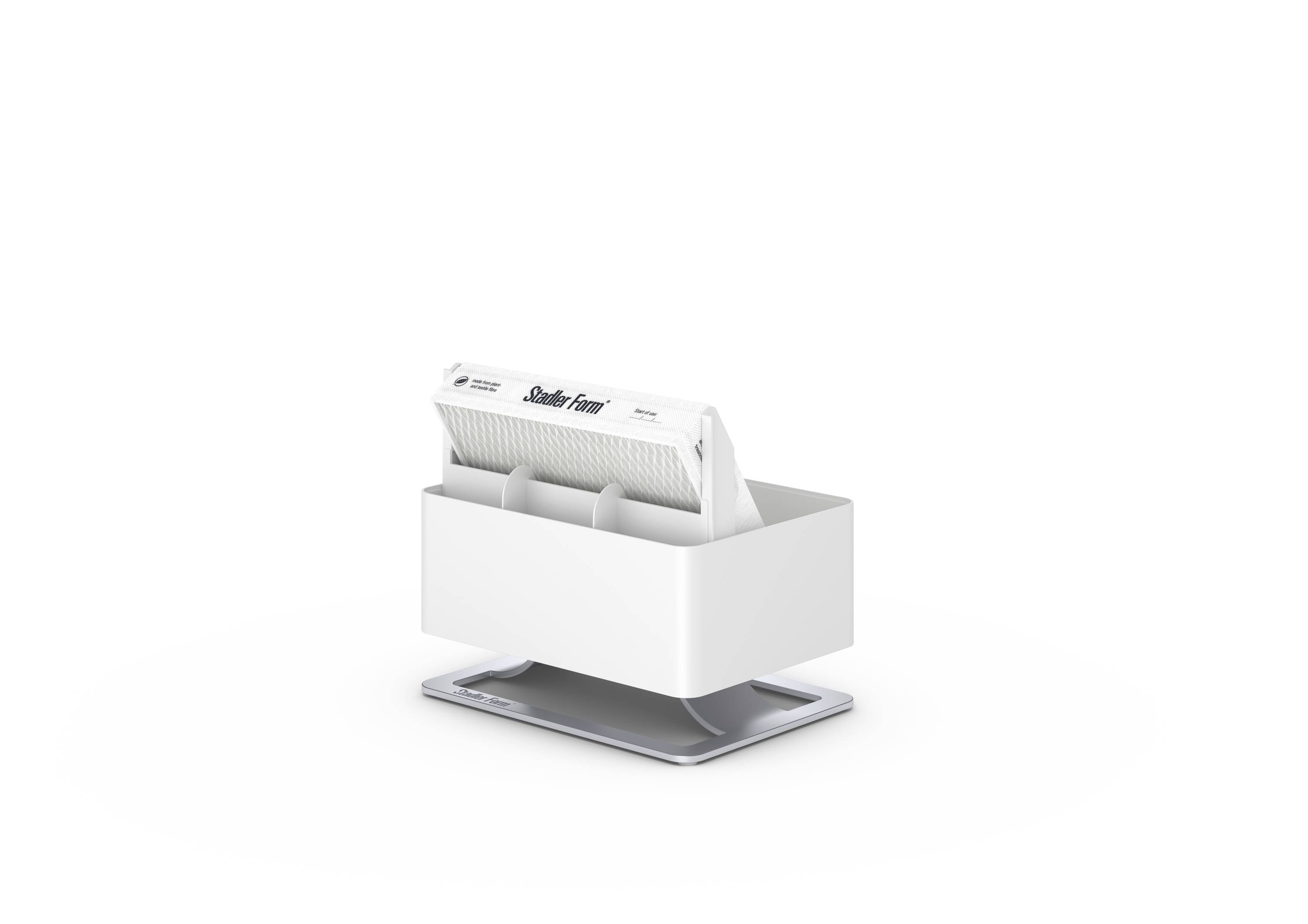 A white card dispenser on a table. The dispenser contains cards with visible card edges. The cards have no discernible text.