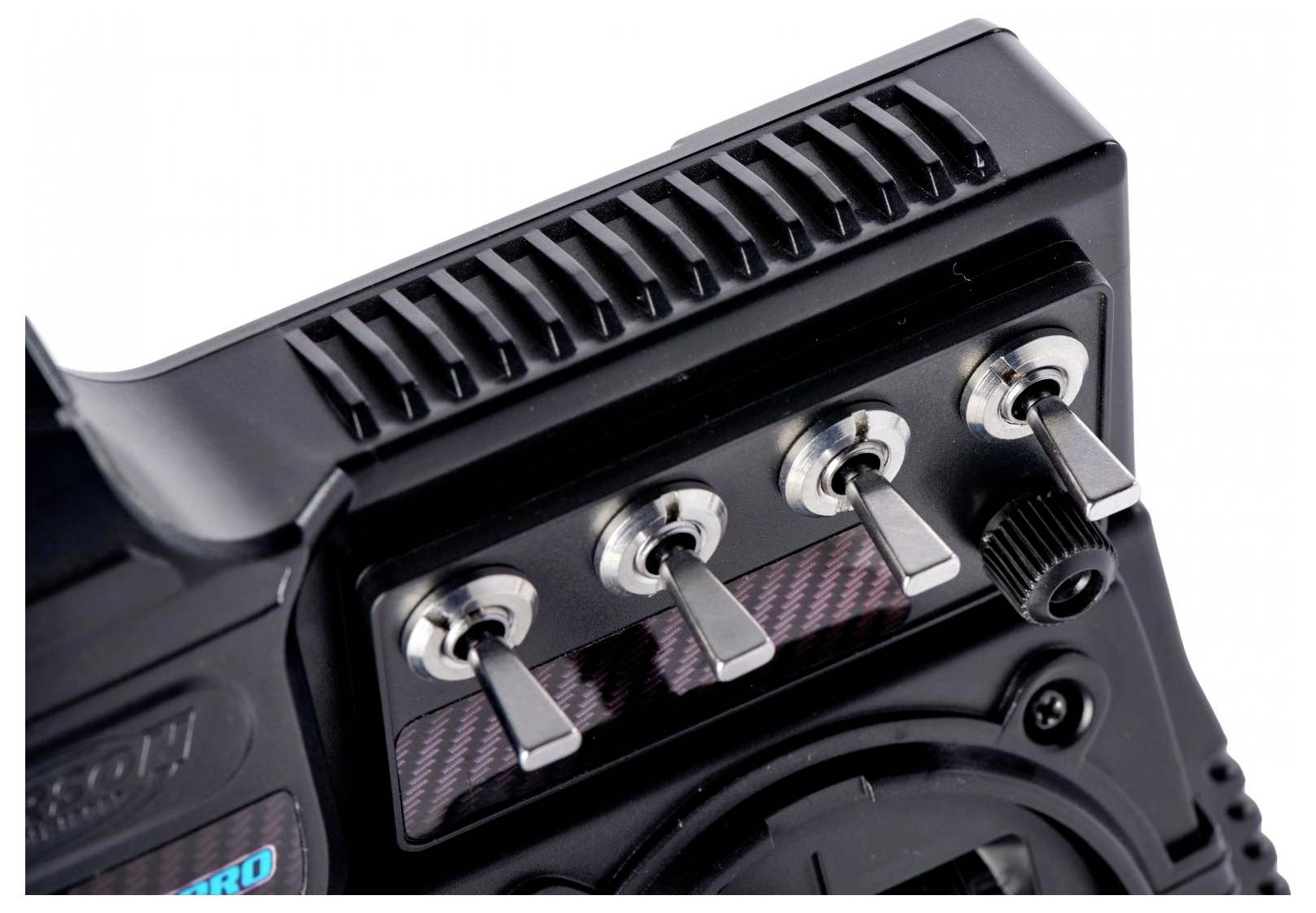 Close-up of a black control panel with four metal toggle switches and a round button, likely part of an electronic device or remote.