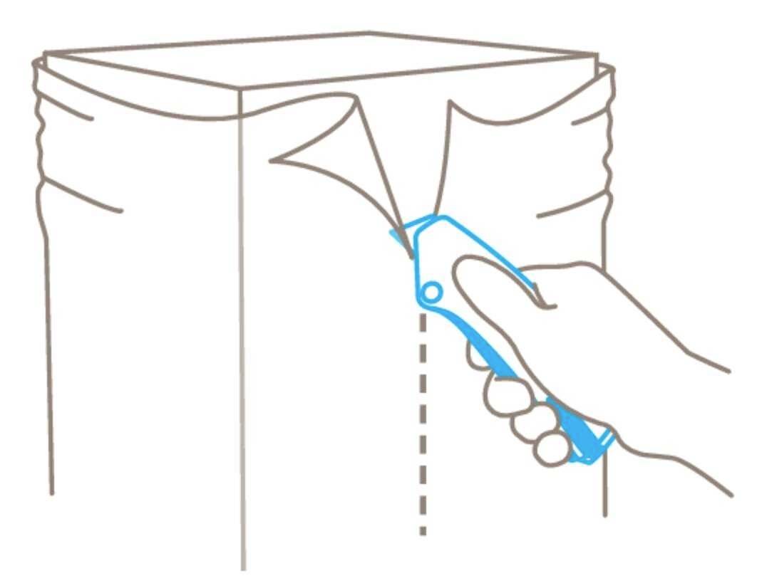 A hand holds a blue craft knife, cutting along a dotted line to open the lid of a rectangular box.