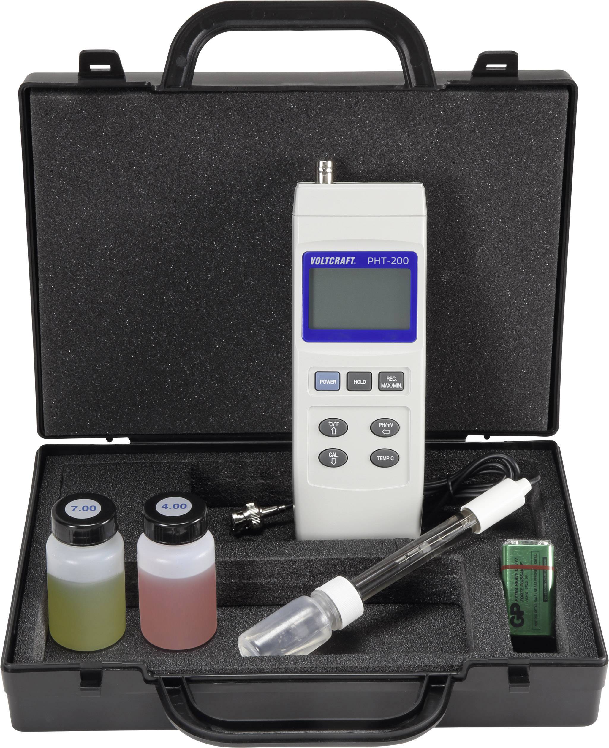 An open case containing a digital pH metre and calibration solutions. The metre features a display and several function buttons.