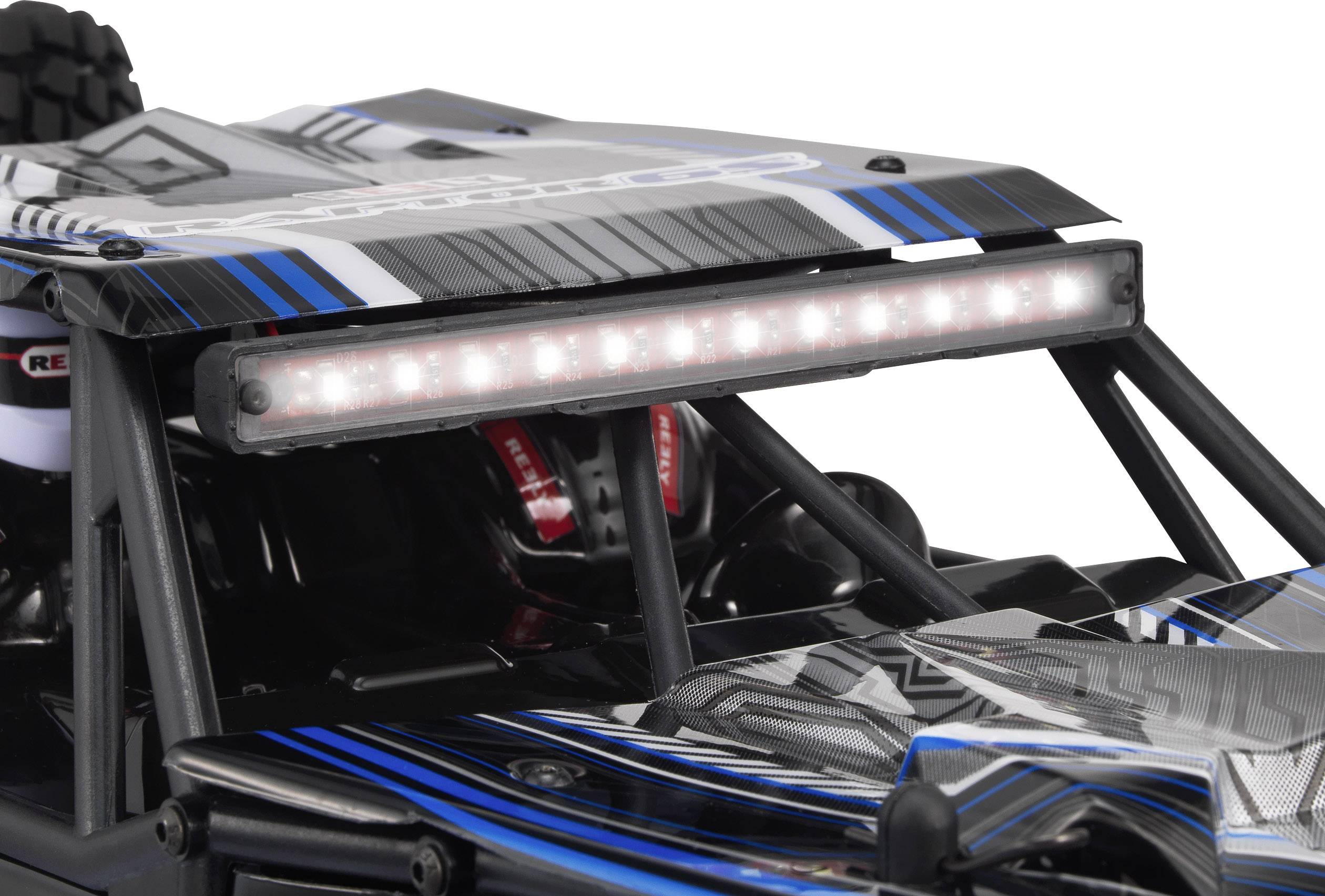 A remote-controlled car in close proximity with a black and blue design and LED light bar on the roof.