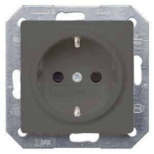 A grey socket with two round holes for plugs, mounted on a metal plate.