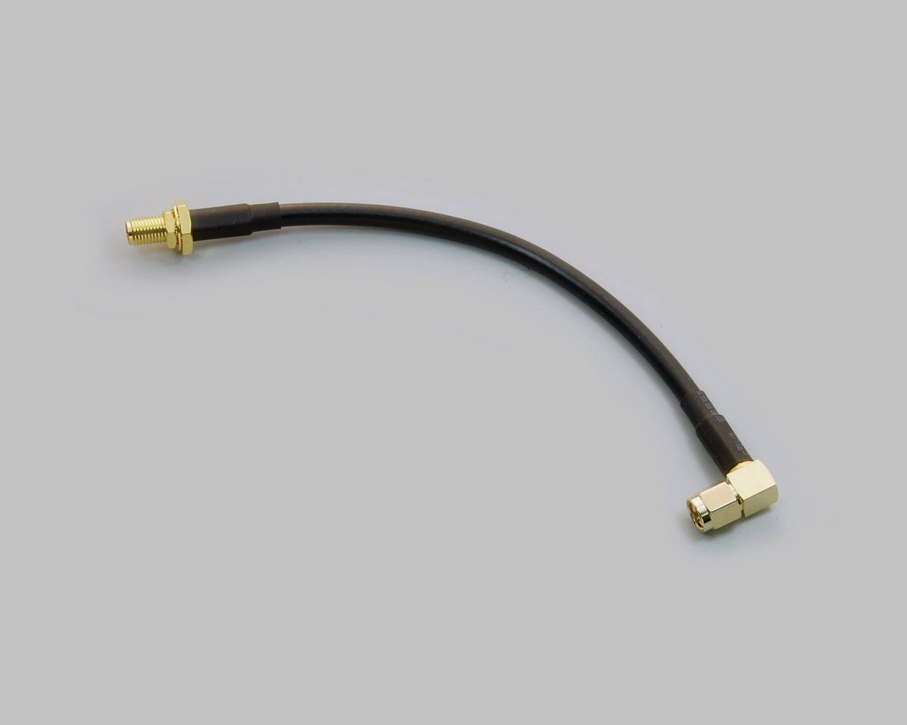 Black coaxial cable with golden connectors at the ends, on a grey background.