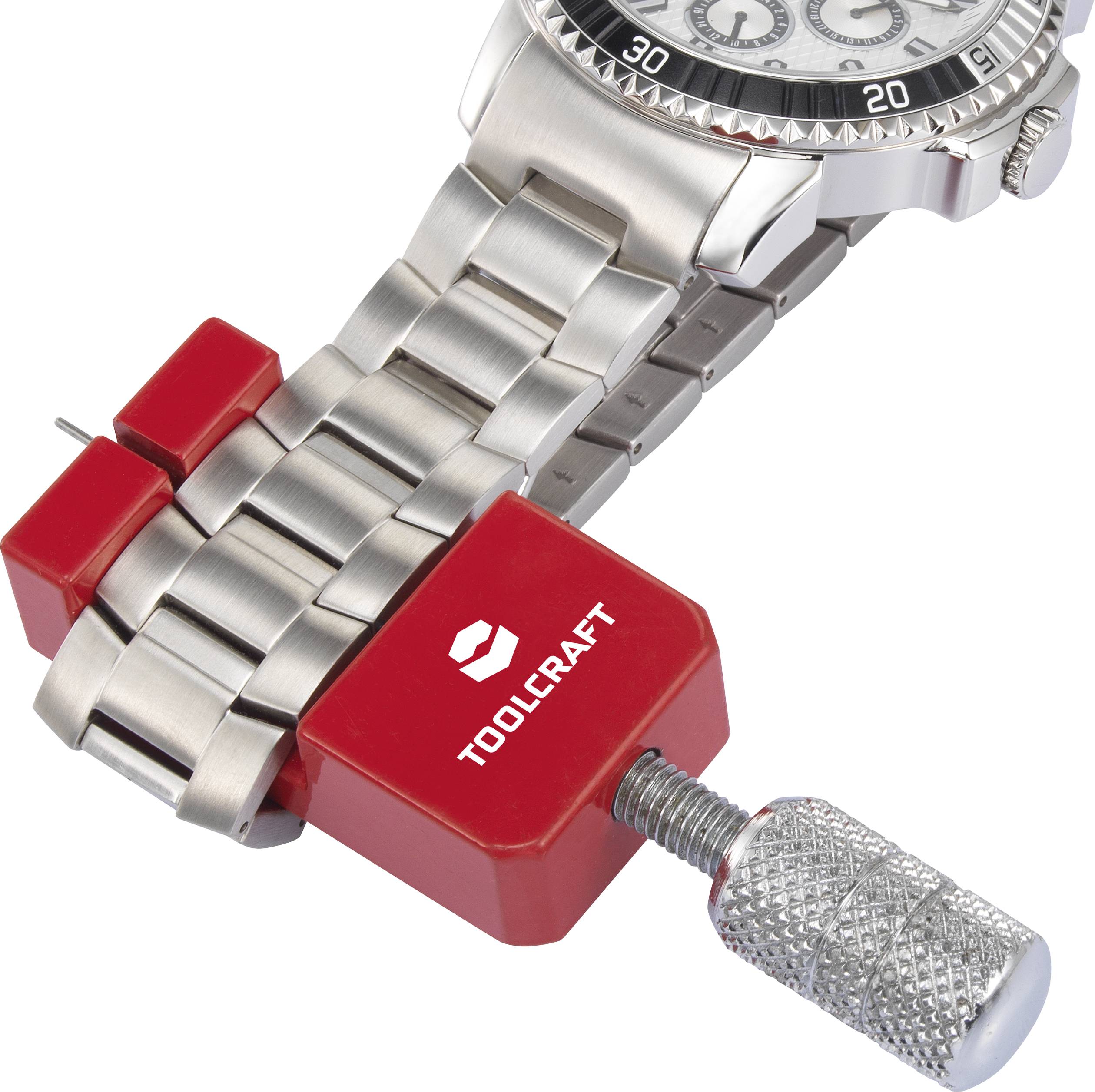 Watch strap clamped in a red toolbox by 'Toolcraft', next to a watch with a silver bracelet.
