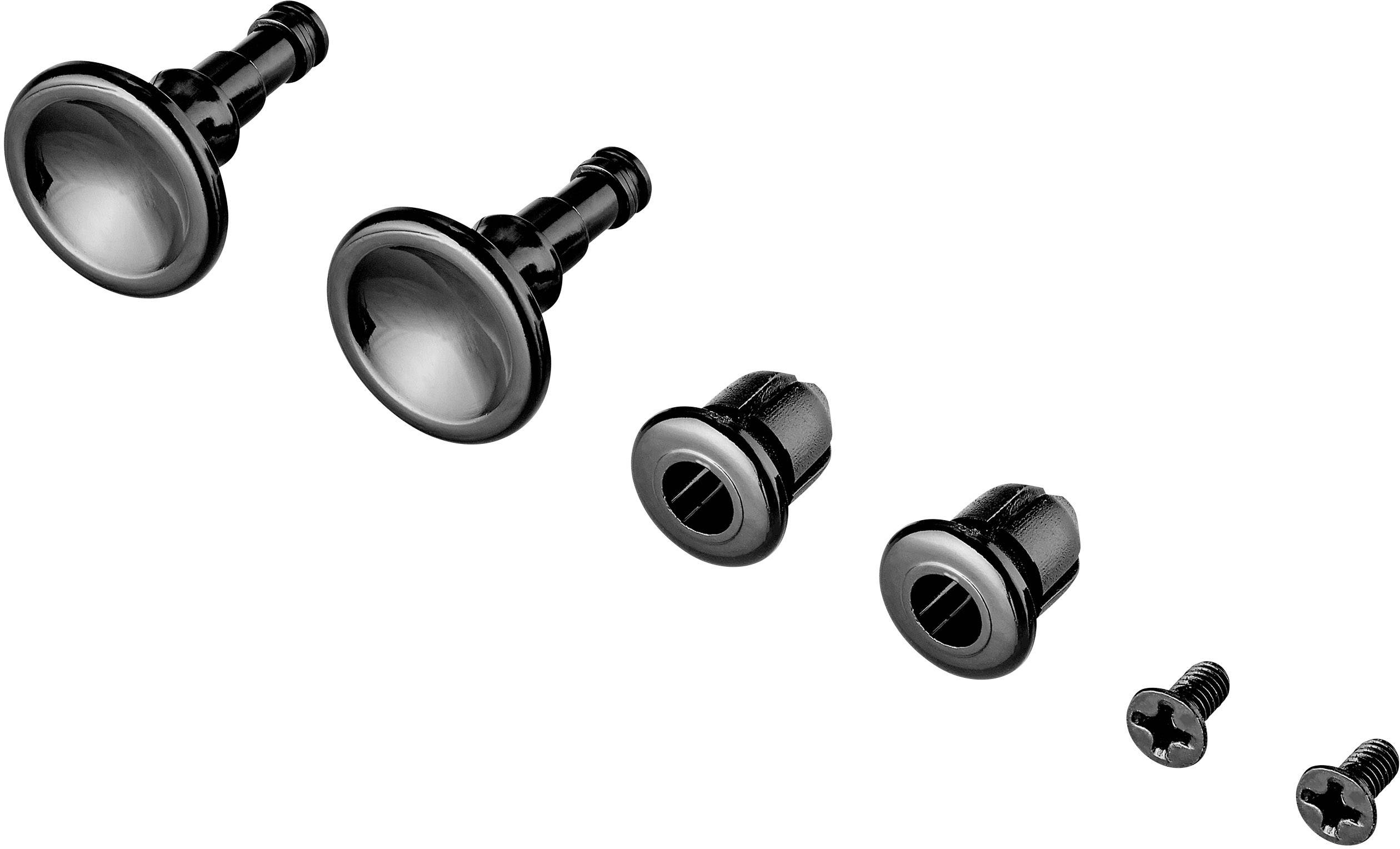 Two black buttons with metal caps, two nuts and two screws are lying side by side. Components for furniture assembly.