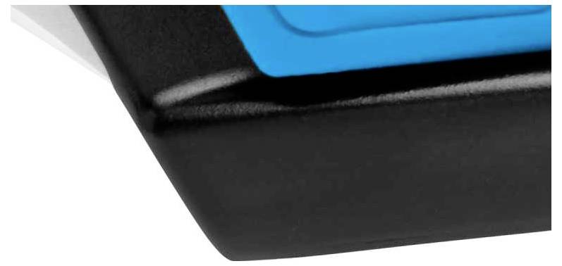 Close-up of a black and blue plastic corner, which may be part of a larger object or piece of furniture.