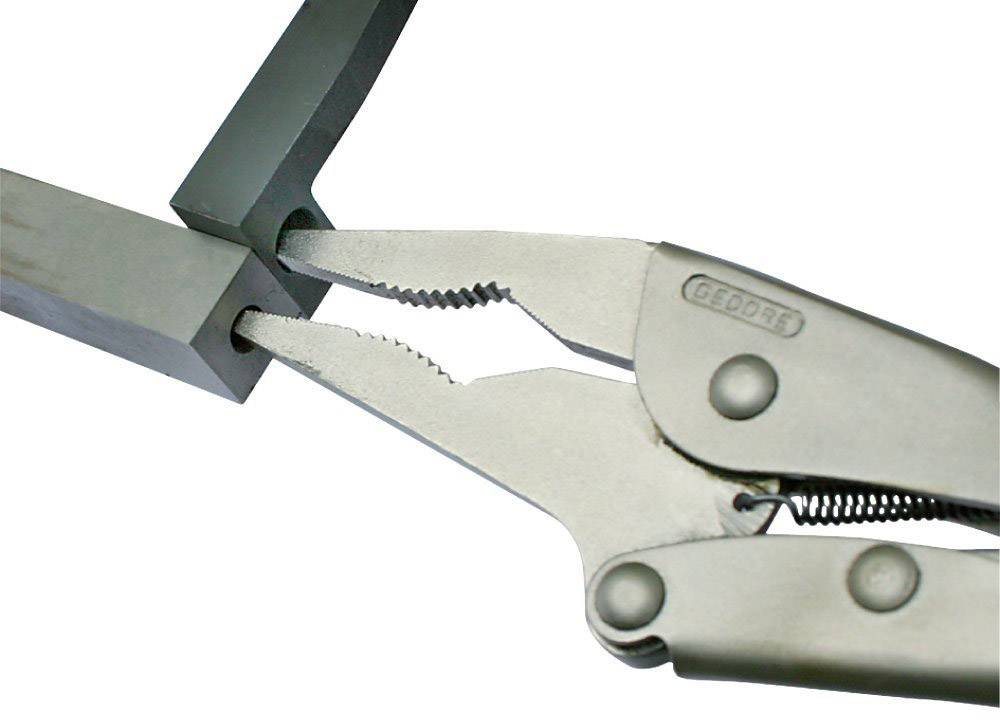 A multi-purpose pliers holds a piece of metal. The pliers have serrated grippers that firmly grip the material.