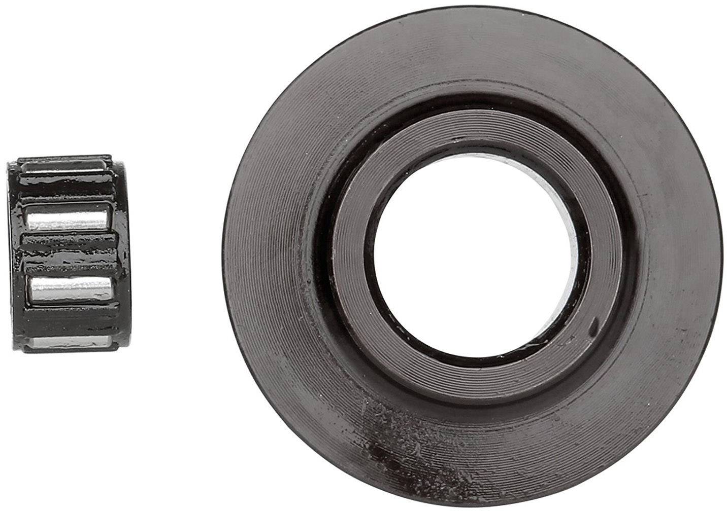 Two mechanical parts: On the right, a large dark disc with a hole in the centre, on the left a small cylindrical roller made of metal.