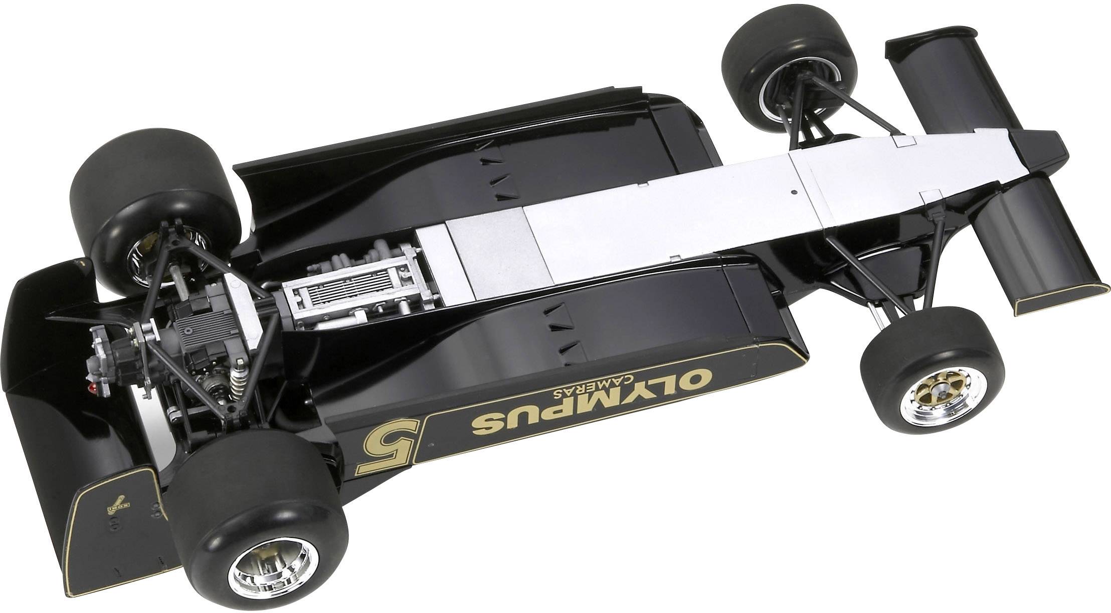 A black Formula 1 racing car with golden stripes and the 'OLYMPUS' lettering on the side, photographed from above.
