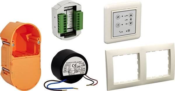 Electronic Components: An orange flush-mounted socket, a module with green terminals, a switch panel with symbols, a round transformer with cables, and a double frame.