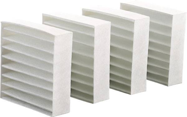 Four white, rectangular air filters with evenly distributed blades, standing side by side. They are used for air purification.