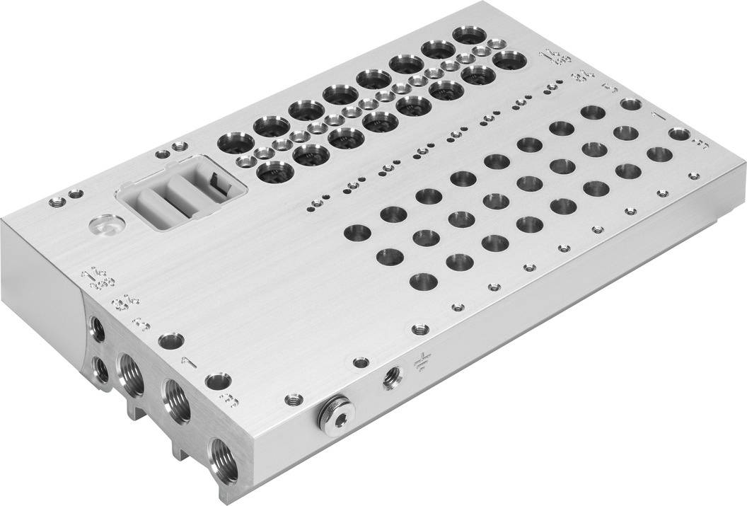 A rectangular metal block with numerous round holes of varying sizes, likely part of a technical device or system.