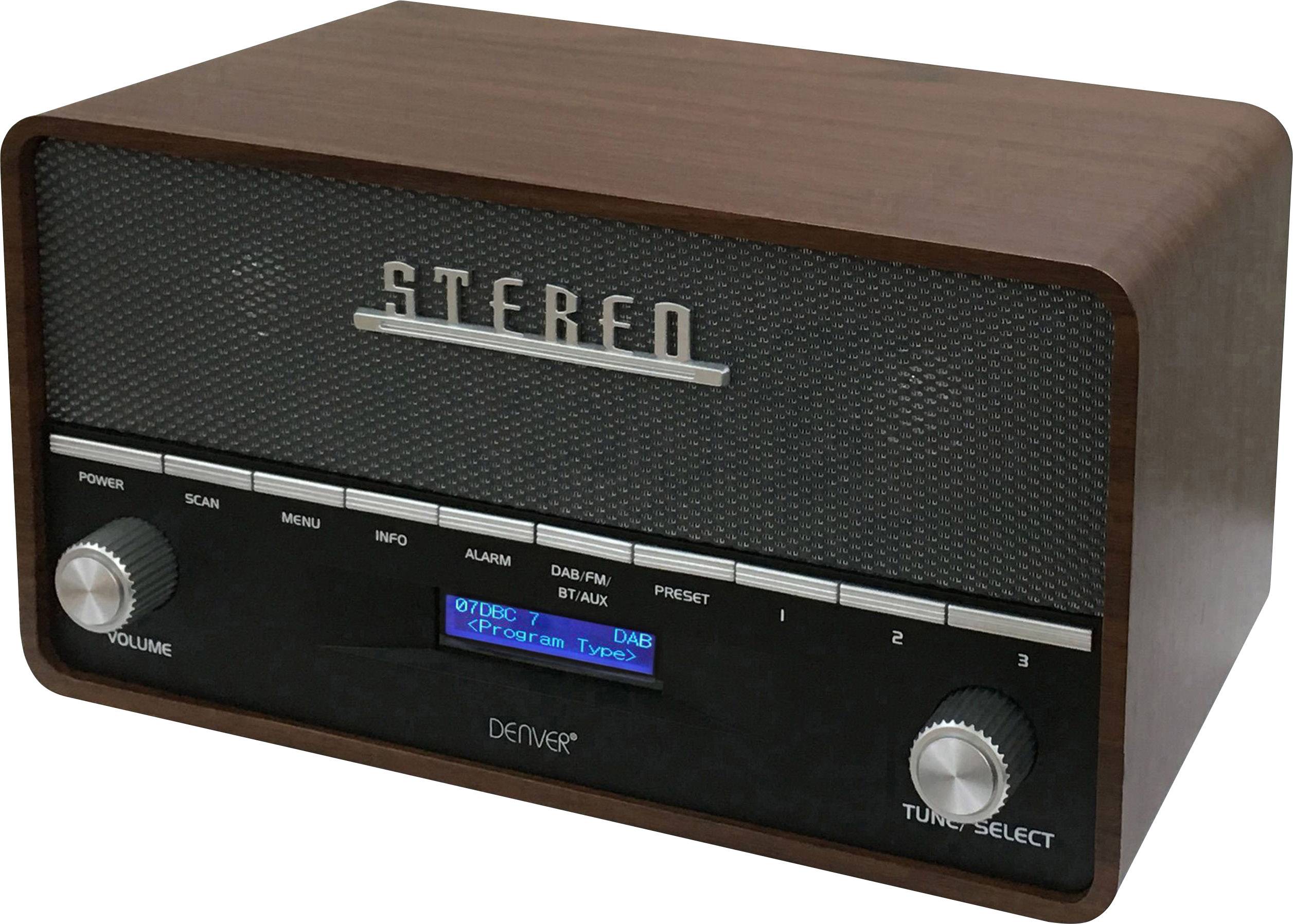 A retro radio in wood-effect finish with digital controls displays 'Stereo' on the front and has buttons for volume and station selection.