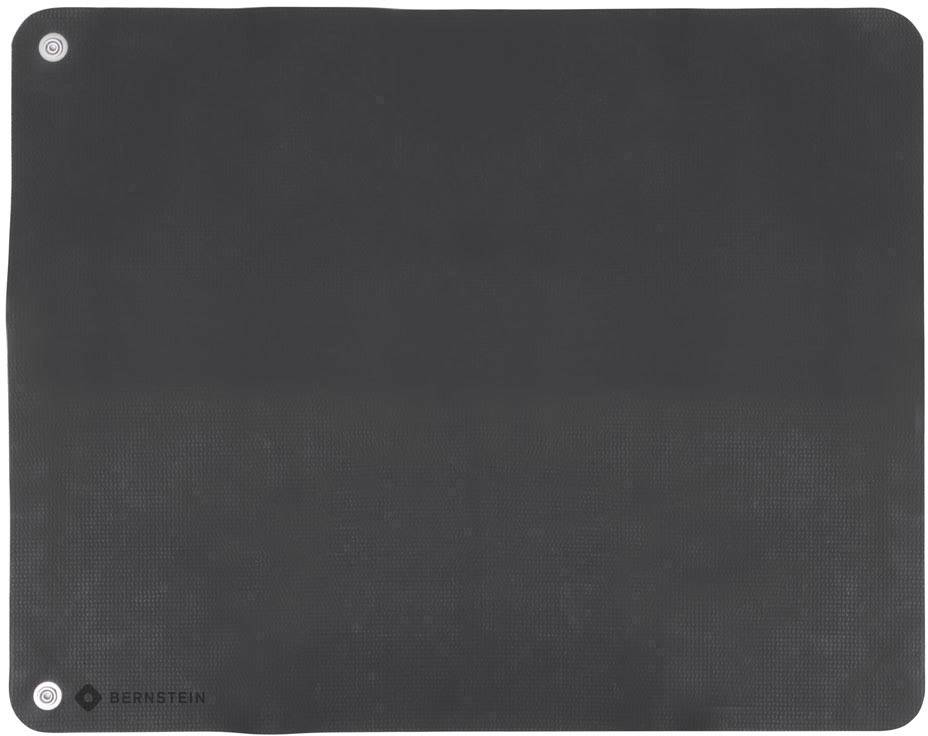 A black anti-fatigue mat from Bernstein. It is rectangular with rounded corners. Suitable for ergonomic standing.