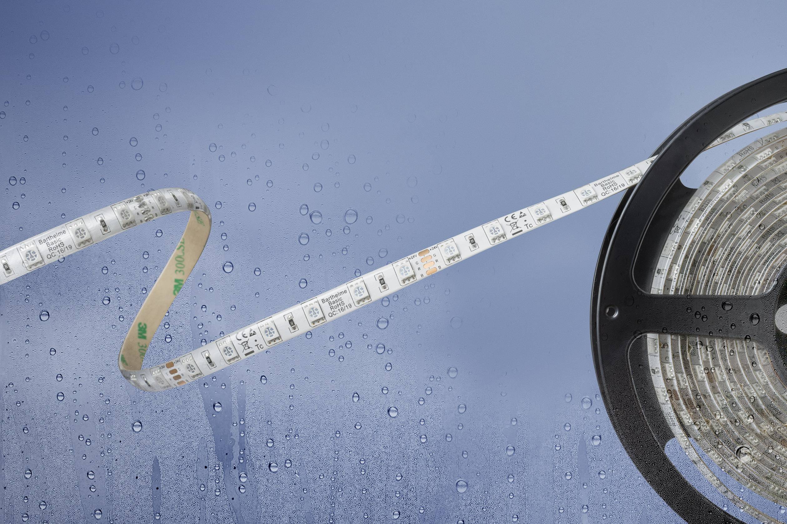 A rolled-up LED light strip with water resistance on a blue, rainy surface, suitable for damp environments.