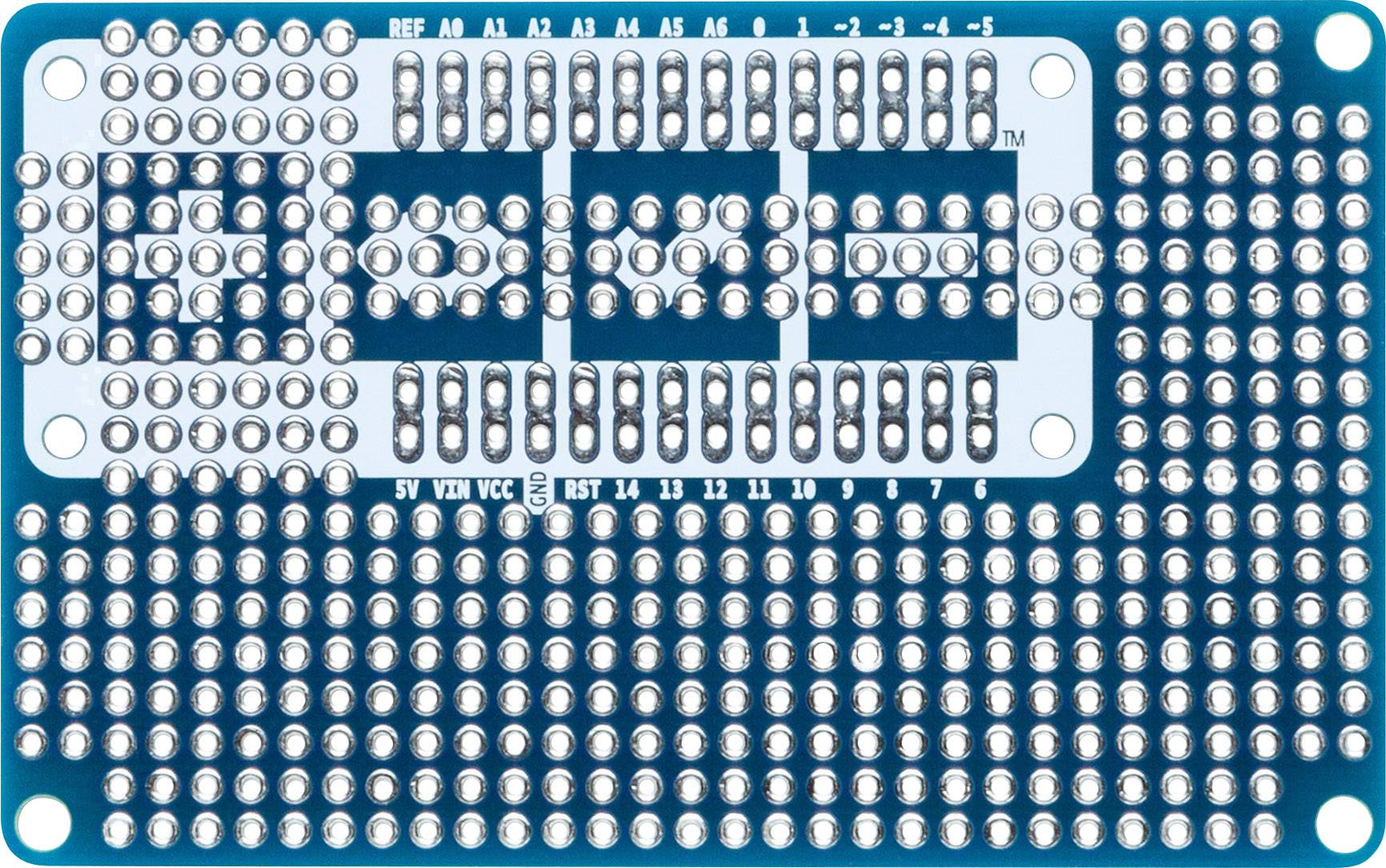 A blue printed circuit board with numerous slots for components and connections. It features markings for various pins.