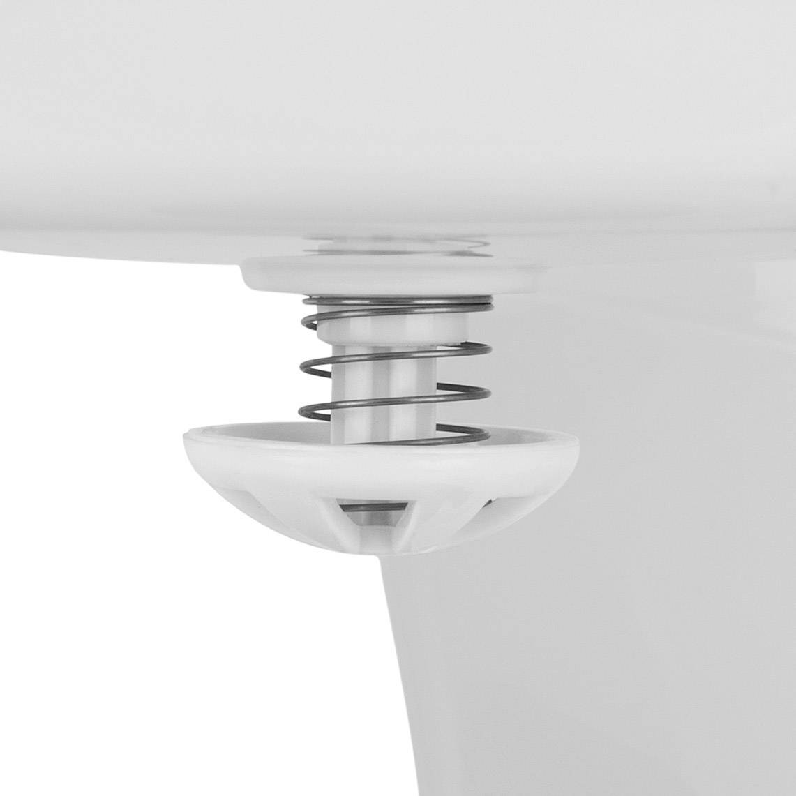 A white push-button plug in a sink plughole, water droplets visible, symbolising plumbing fixtures in the bathroom.