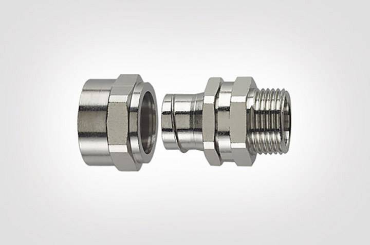 Two metal connecting pieces, one with an internal thread and the other with an external thread, in close-up against a neutral background.