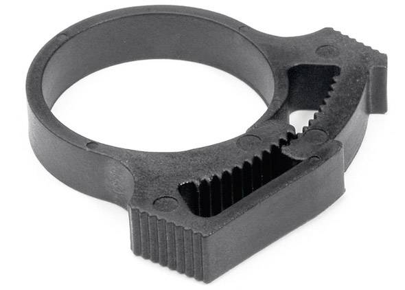 A black plastic ring with serrated edges and a flat top surface. Possibly a component of a mechanical device or tool.