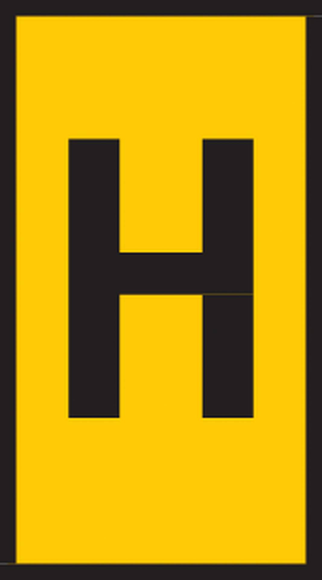A yellow road sign with a large, black 'H', indicating a bus stop.
