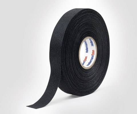A black roll of adhesive tape is standing upright.