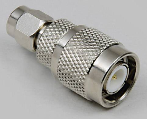 A metal plug with a ribbed surface and a central pin connection, commonly used for cable connections.