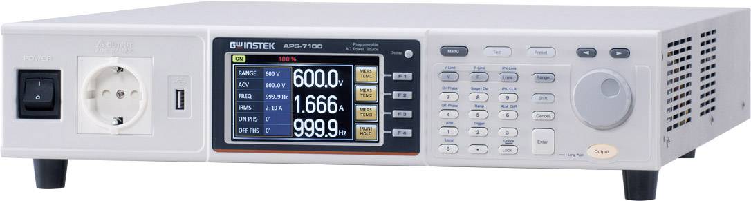 Electrical testing device with display showing readings: voltage, current, frequency. Control panel with buttons and rotary dial on the right.