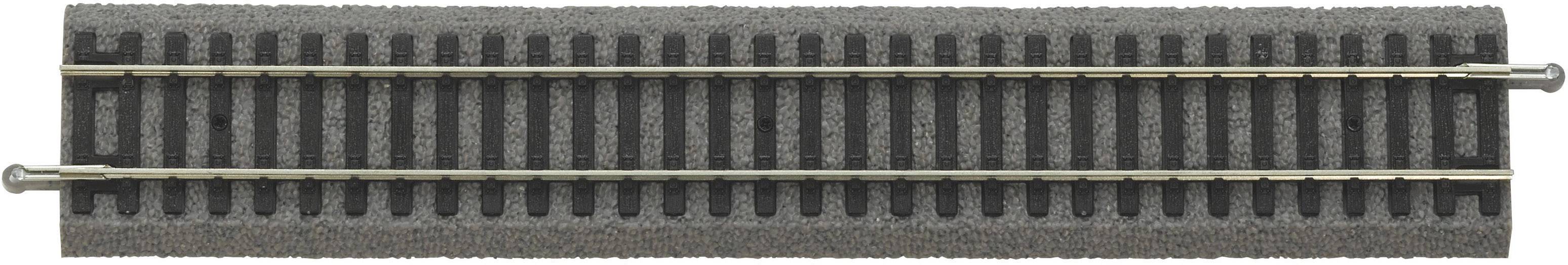 Plastic track section with two metal rails, likely part of a model railway, square sleepers visible.