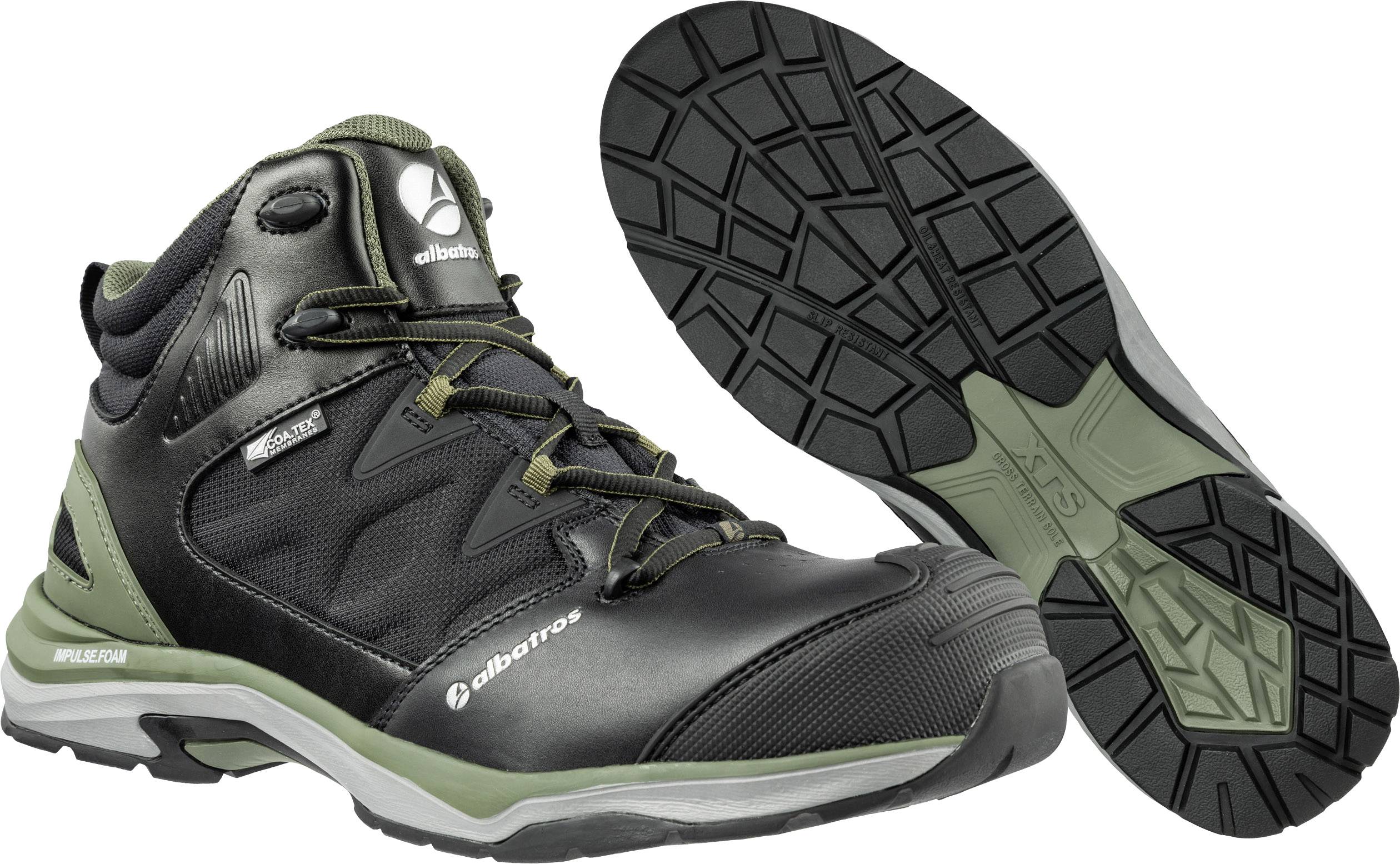 Black trekking boots with a green accent and light sole, suitable for outdoor activities. Brand name visible on the side.