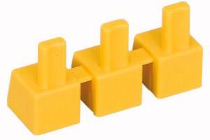 Three yellow interconnected plastic blocks, each with a raised rectangular peg on every block.