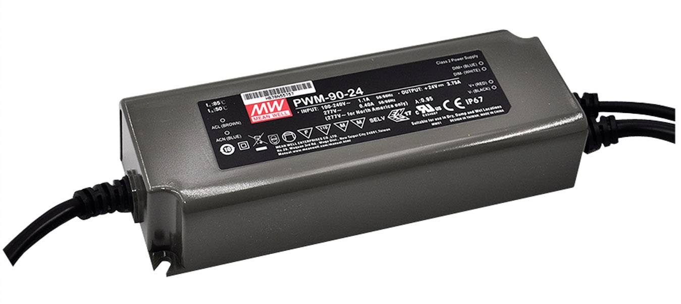 A rectangular electronic device with the inscription 'PWM-90-24', connected by two cables, is lying on a surface.