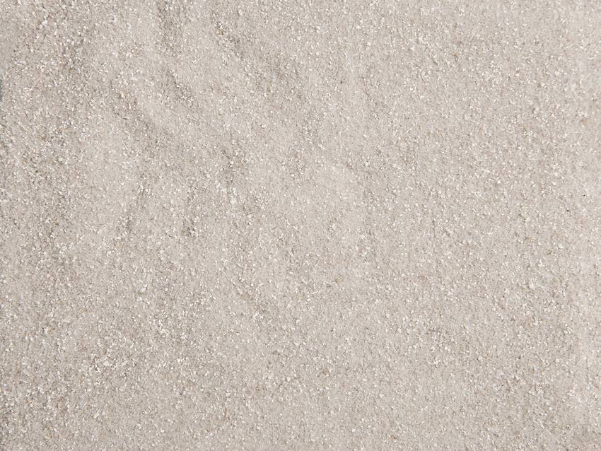 Fine, light sand without discernible patterns or shapes, evenly distributed.