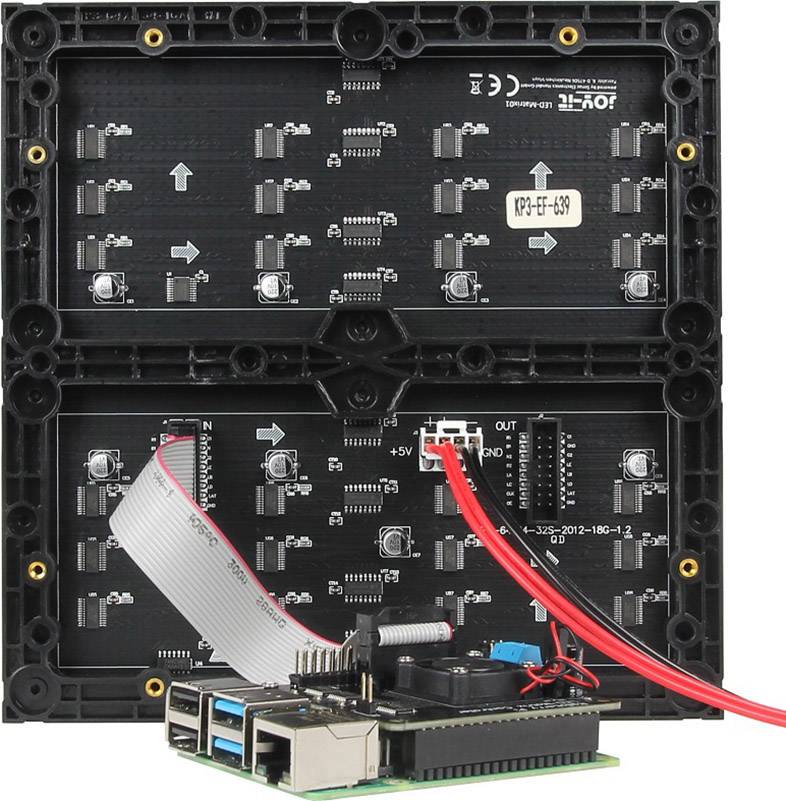 Two LED panels with visible circuit boards, connected via red and grey cables to a small circuit board at the bottom.