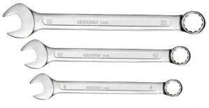 Three silver spanners of different sizes lying side by side. Each has an open and a ring-shaped end.