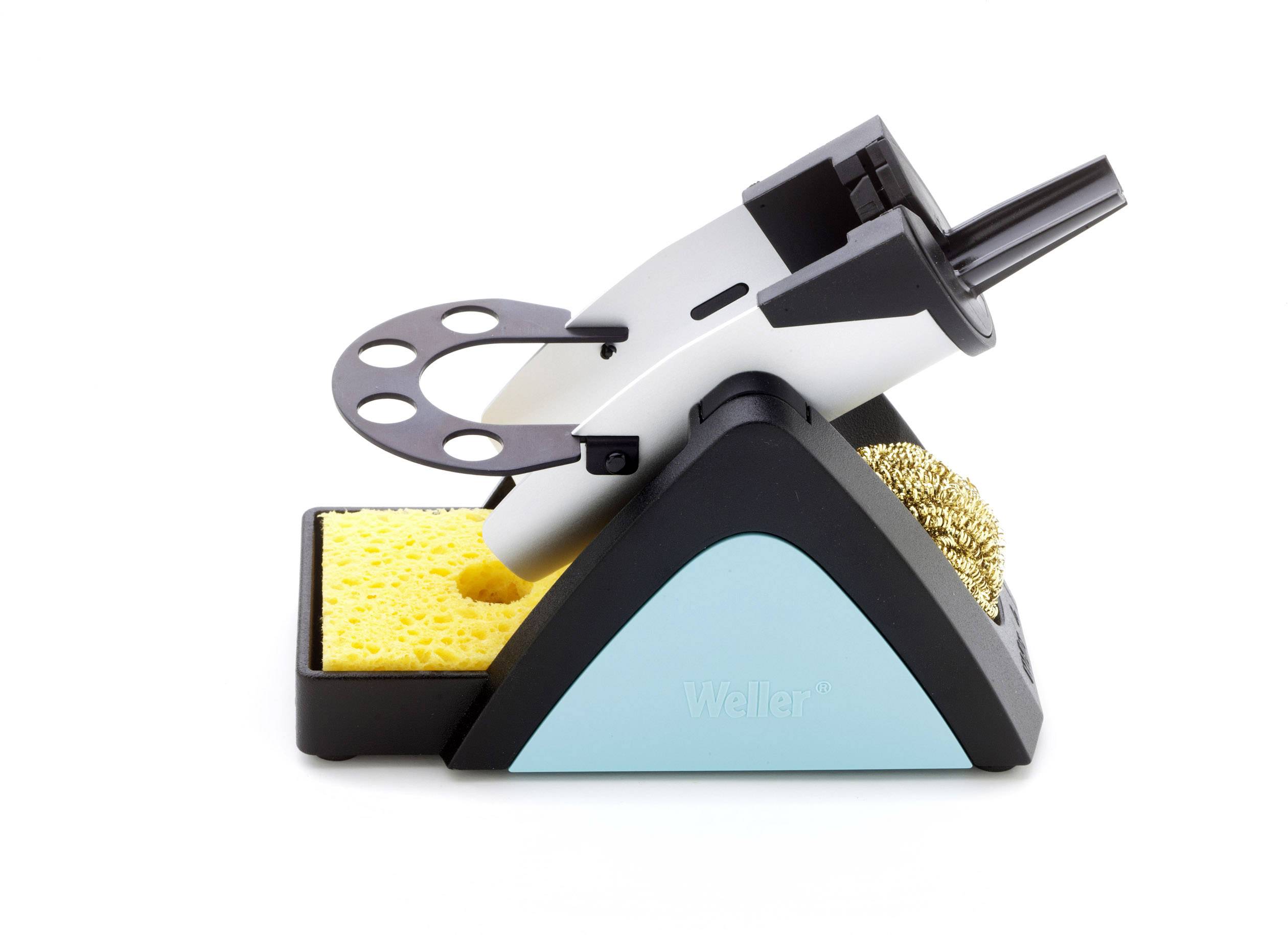 A soldering iron holder with a soldering iron in a stand on a yellow sponge. A cleaning pad is visible on the right.