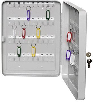 An open key cabinet with several labelled key fobs in different colours, hanging on numbered hooks.