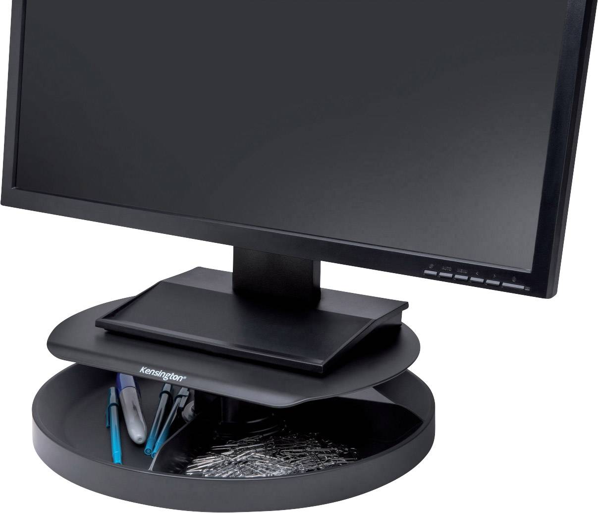 A black computer monitor sits on a round stand with an integrated compartment for office supplies such as pens and paperclips.