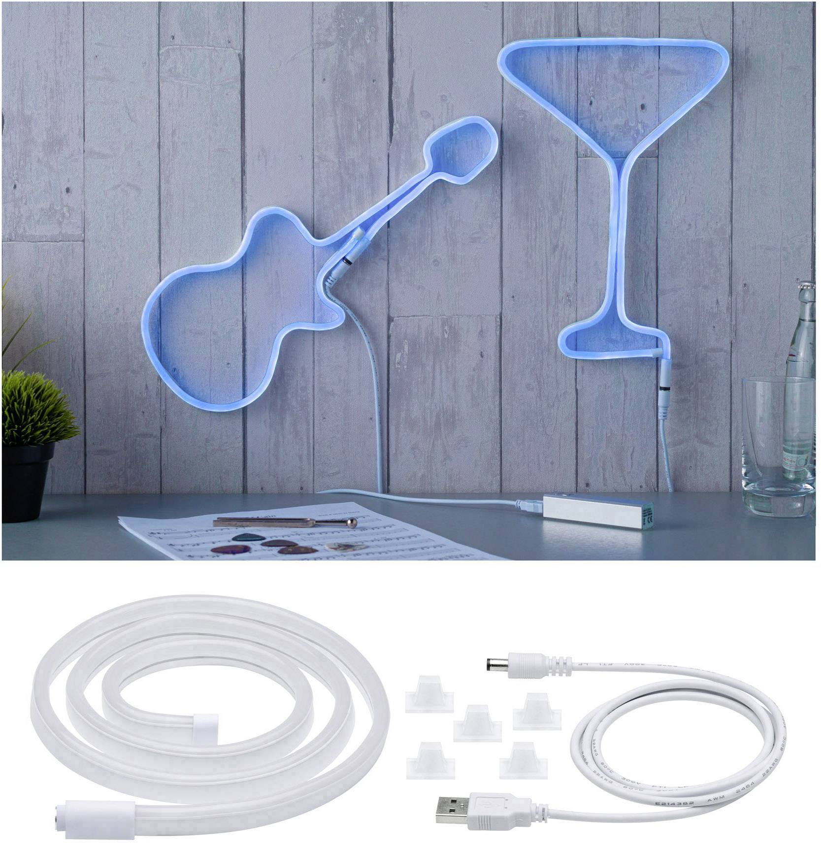 A wall decoration in the shape of an illuminated guitar and a cocktail glass. Beneath it, a USB cable and accessories on a table.